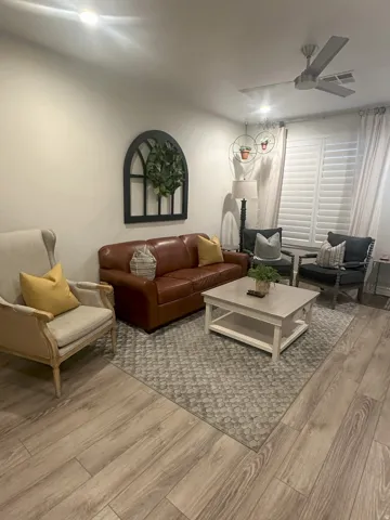 Living room featuring wood finished floors and a ceiling fan