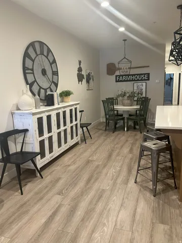 Dining space featuring light wood-type flooring and baseboards