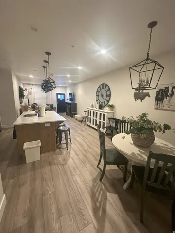 Dining area with a chandelier and light wood-style flooring
