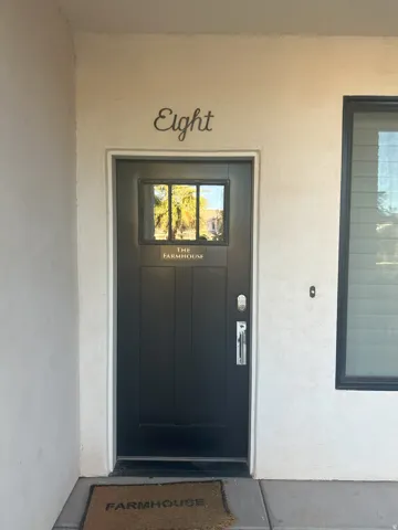 View of exterior entry with stucco siding