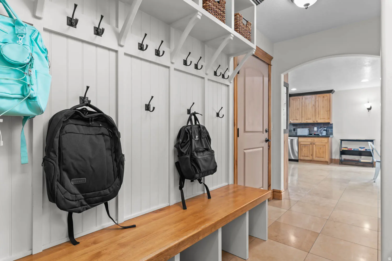 Mudroom with arched walkways, light tile patterned flooring, and recessed lighting