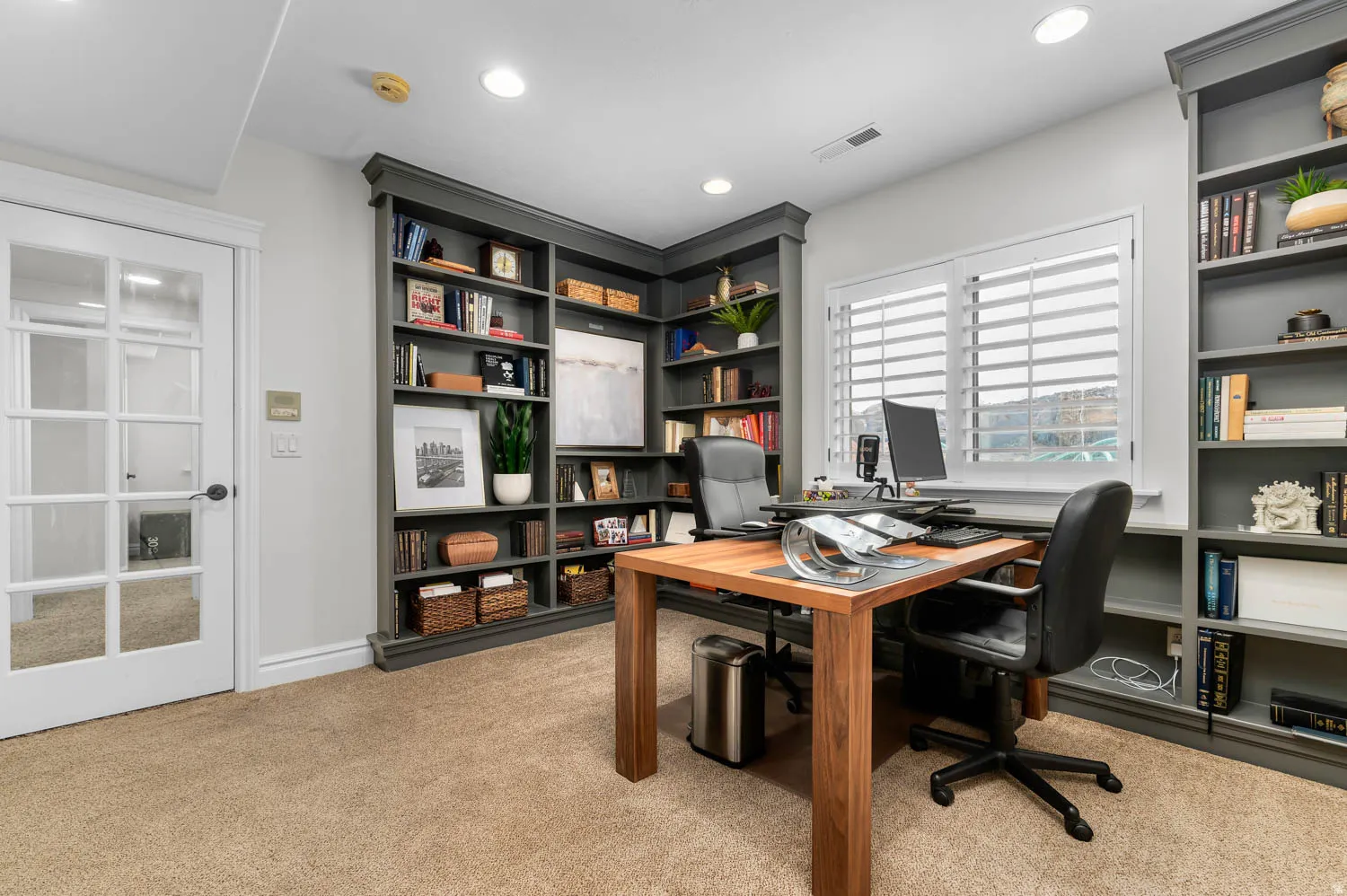 Office space with light colored carpet, recessed lighting, and built in features