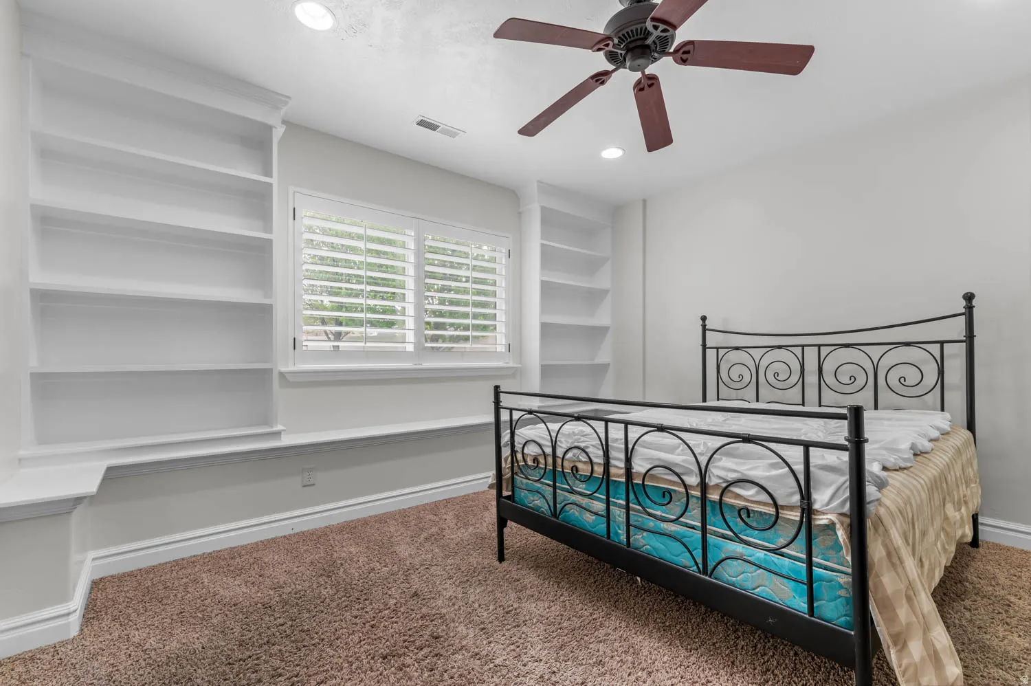 Bedroom with dark colored carpet, recessed lighting, and a ceiling fan