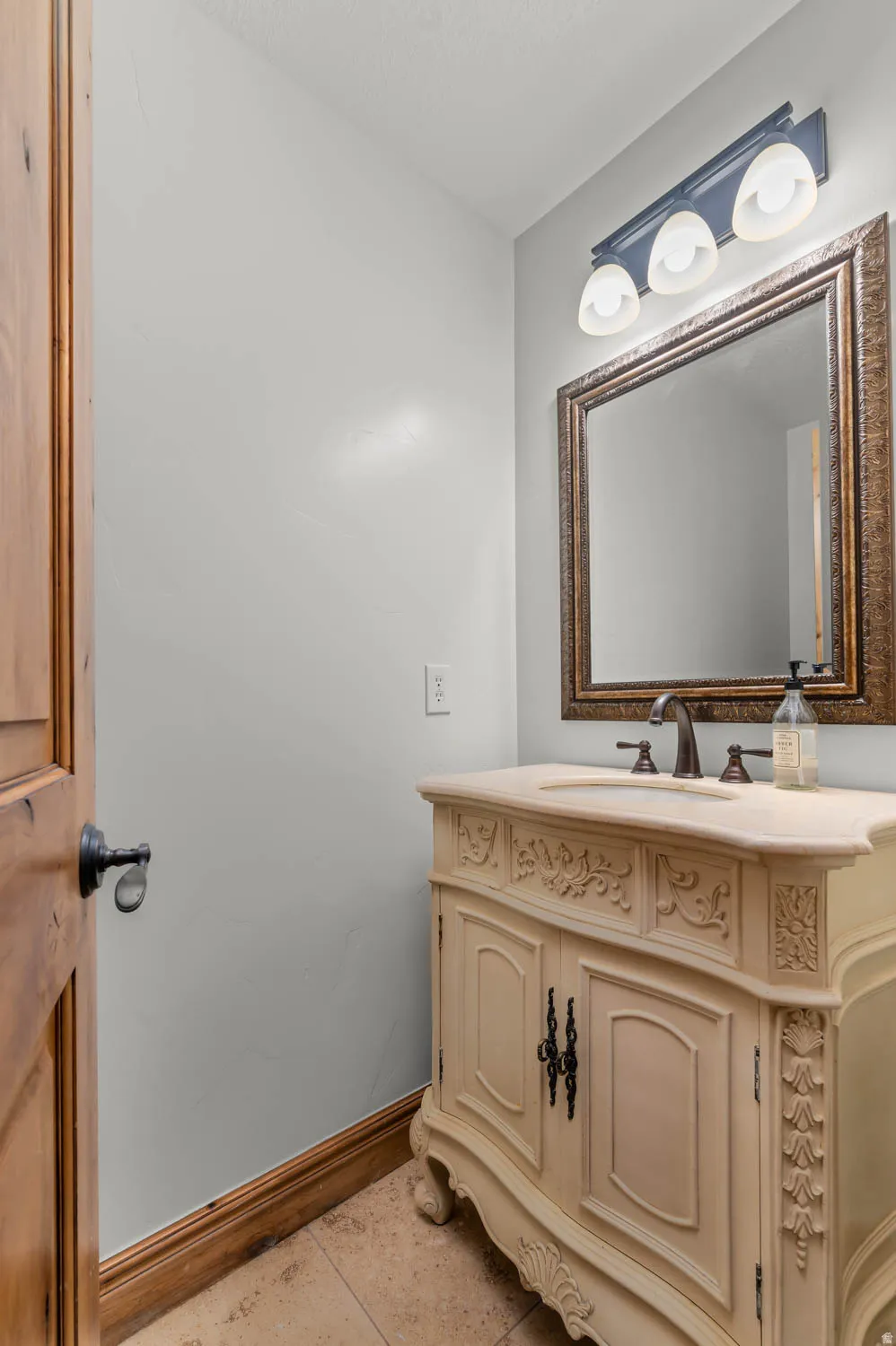 Bathroom featuring vanity and baseboards