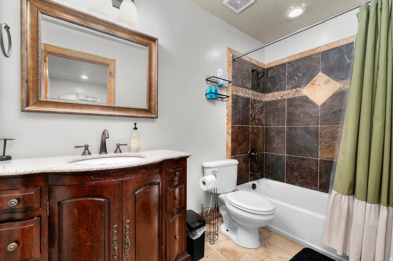 Bathroom with vanity, shower / tub combo, light tile patterned flooring, and recessed lighting