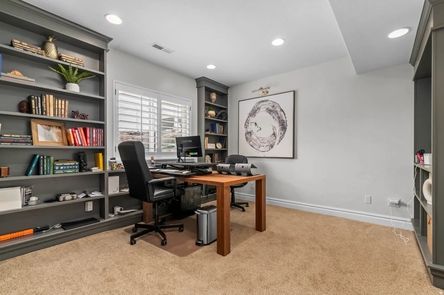 Office area featuring light colored carpet, recessed lighting, and built in shelves