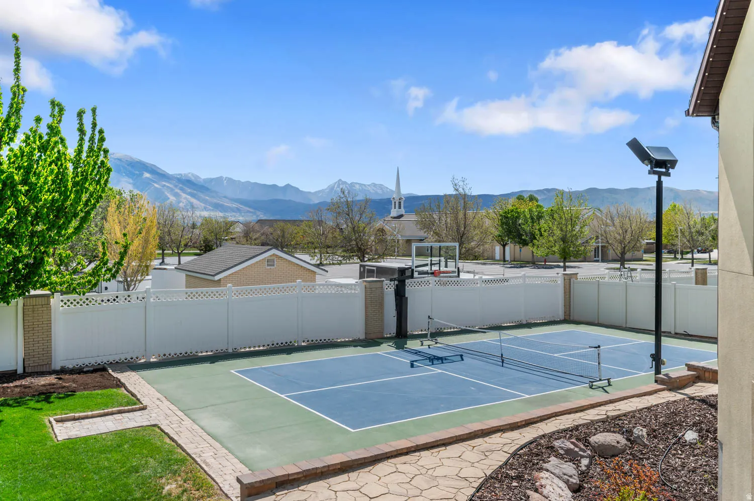 View of sport court featuring a tennis court, a mountain view, and community basketball court