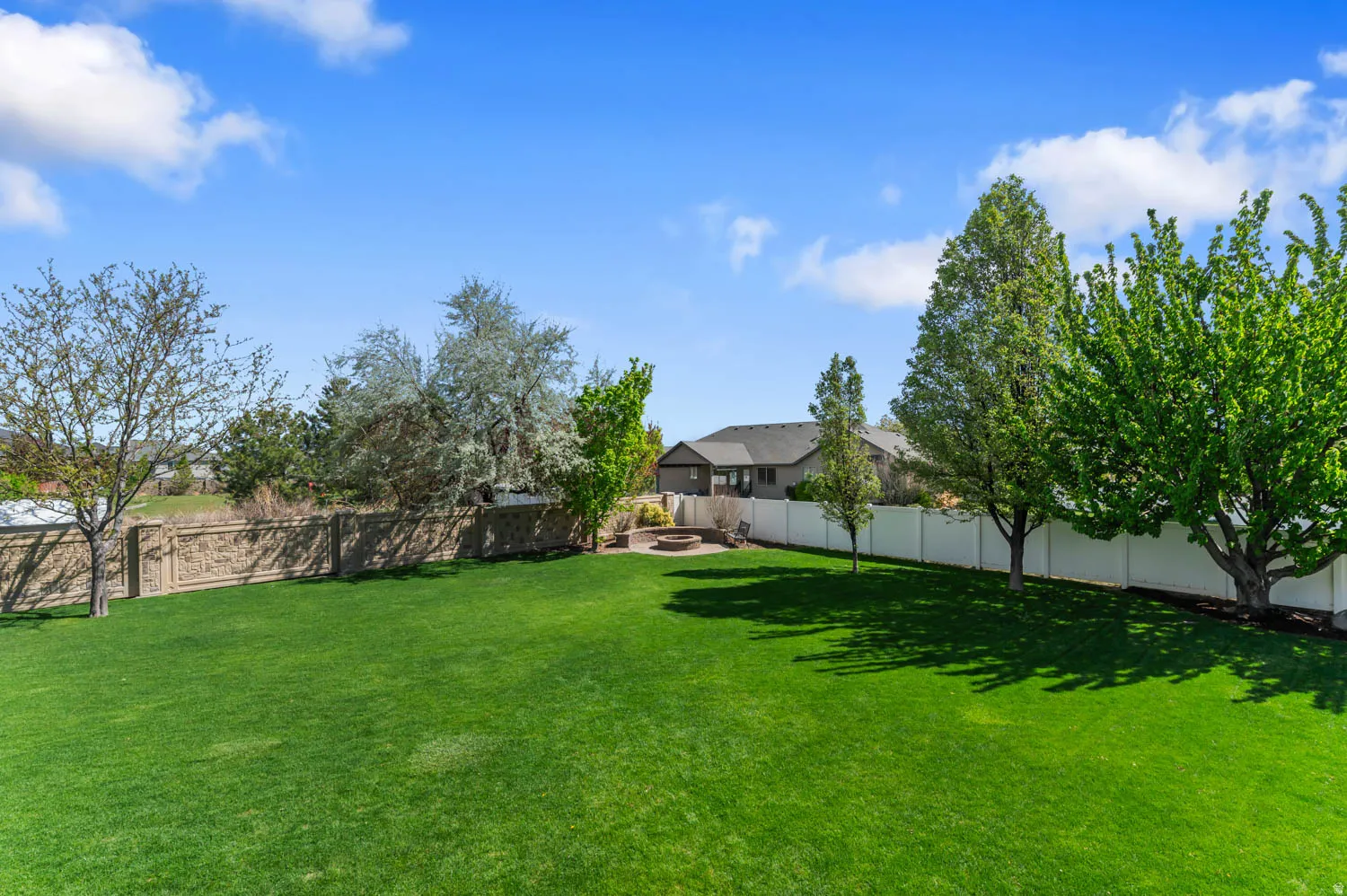 Fenced backyard with a patio