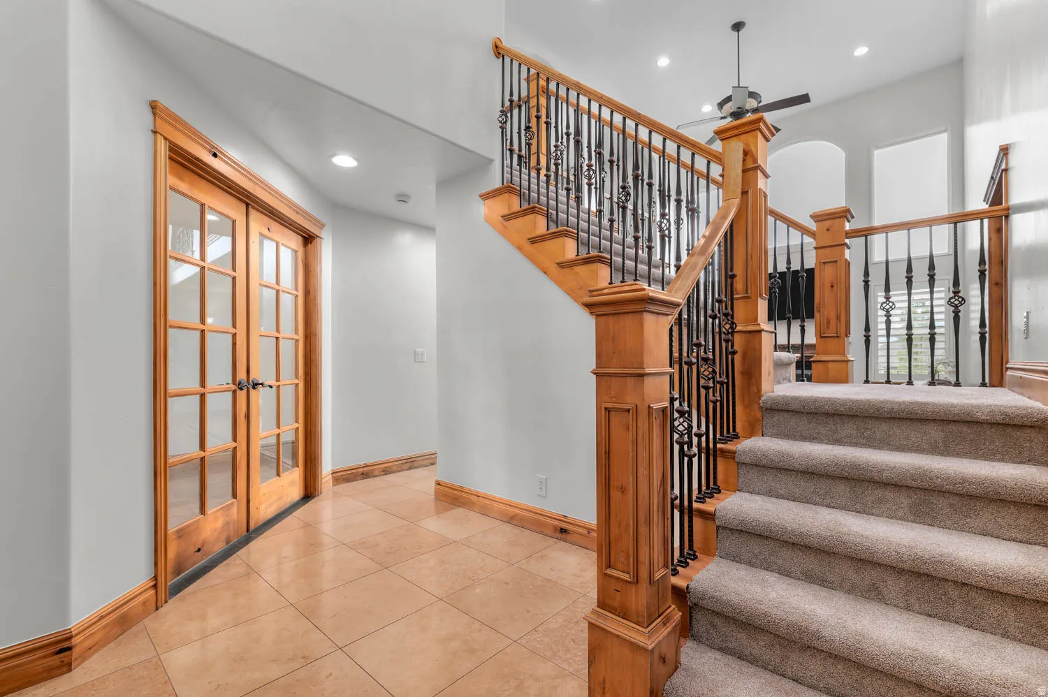 Stairs featuring tile patterned flooring, recessed lighting, a ceiling fan, and french doors