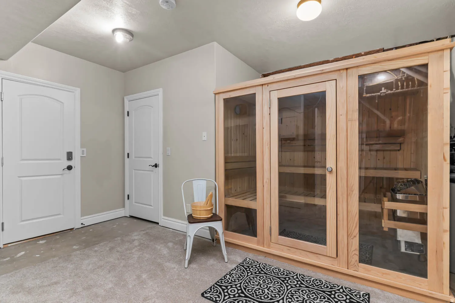 Sauna / steam room with carpet and baseboards