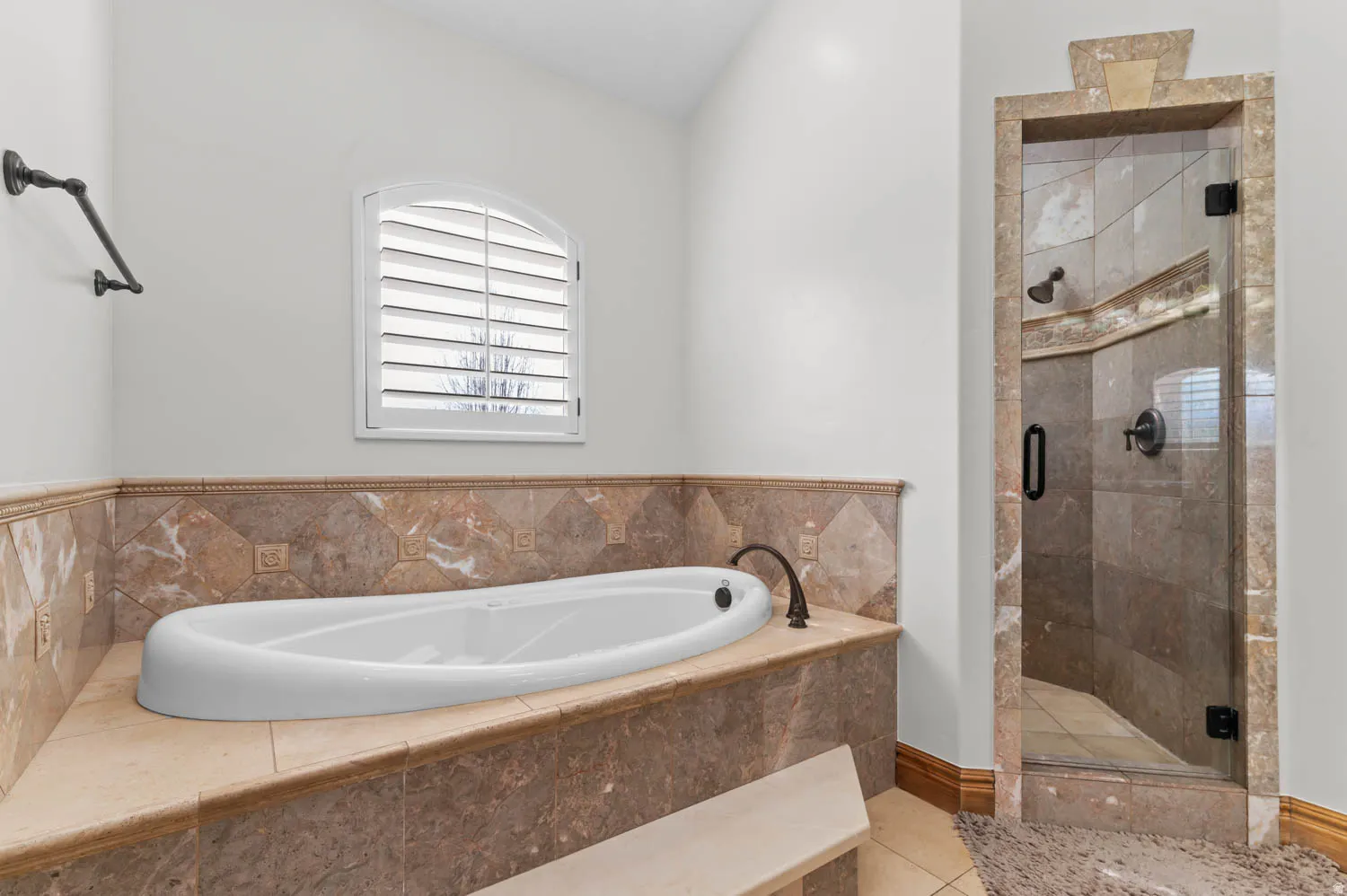 Full bath with a stall shower, a bath, and light tile patterned floors