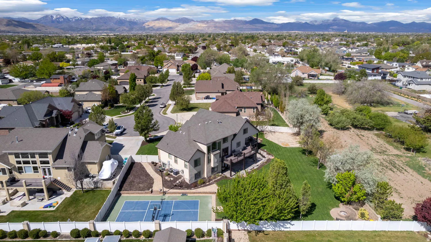 Aerial perspective of suburban area with a mountainous background