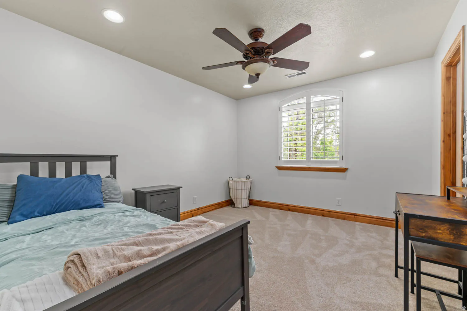 Bedroom with light colored carpet, a ceiling fan, and recessed lighting