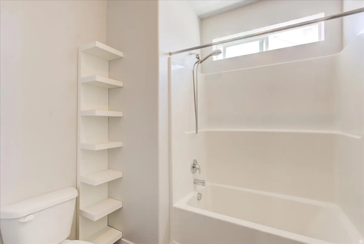 Bathroom with tub / shower combination and toilet