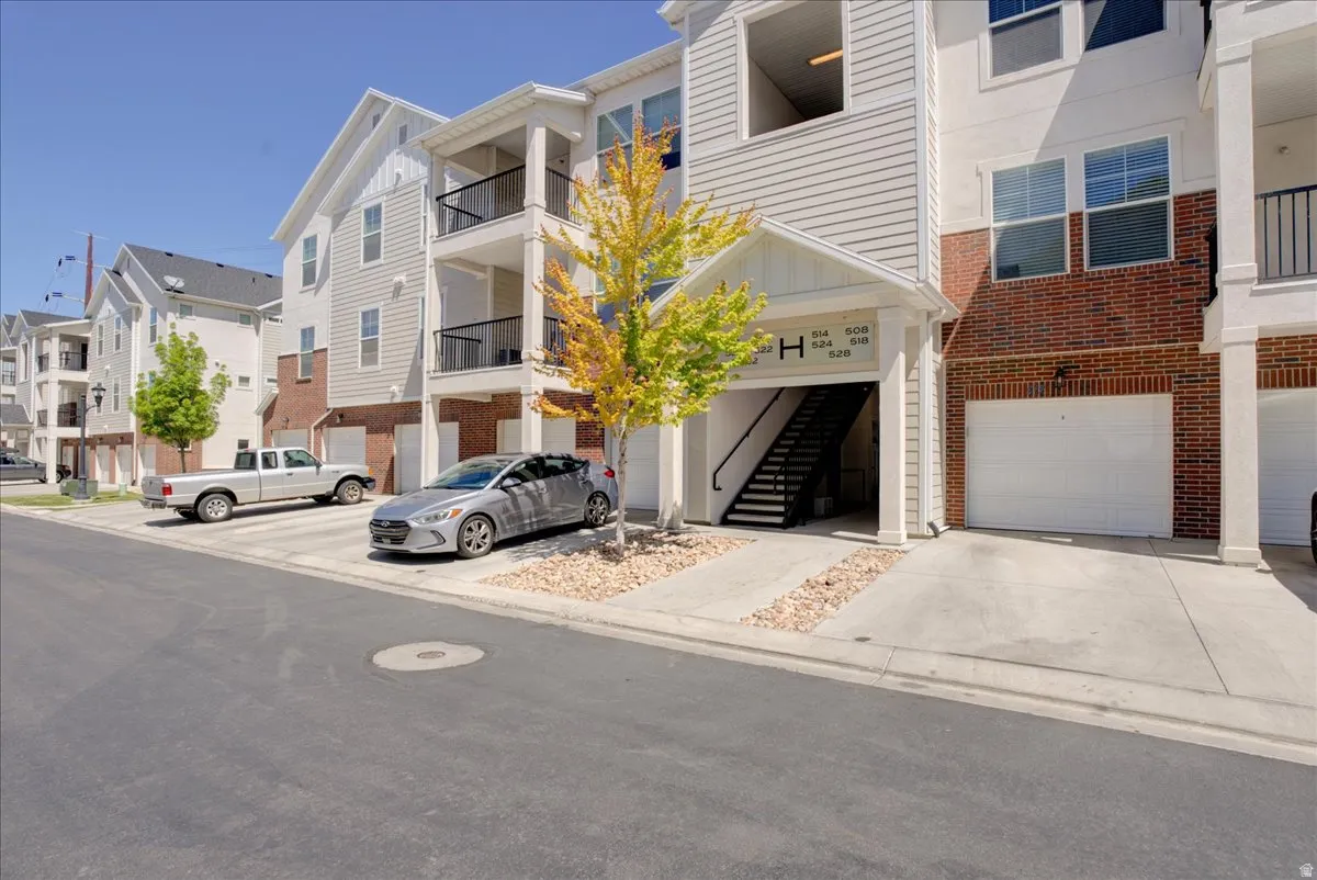 View of property featuring a garage and driveway