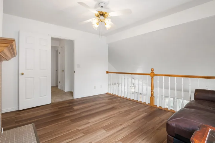 Living area with a ceiling fan and laminate floors