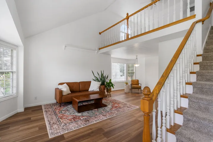 Vaulted ceiling in living space with wood-finish flooring