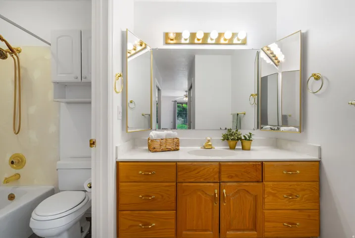 Wood-finish vanity with a white countertop and integrated sink