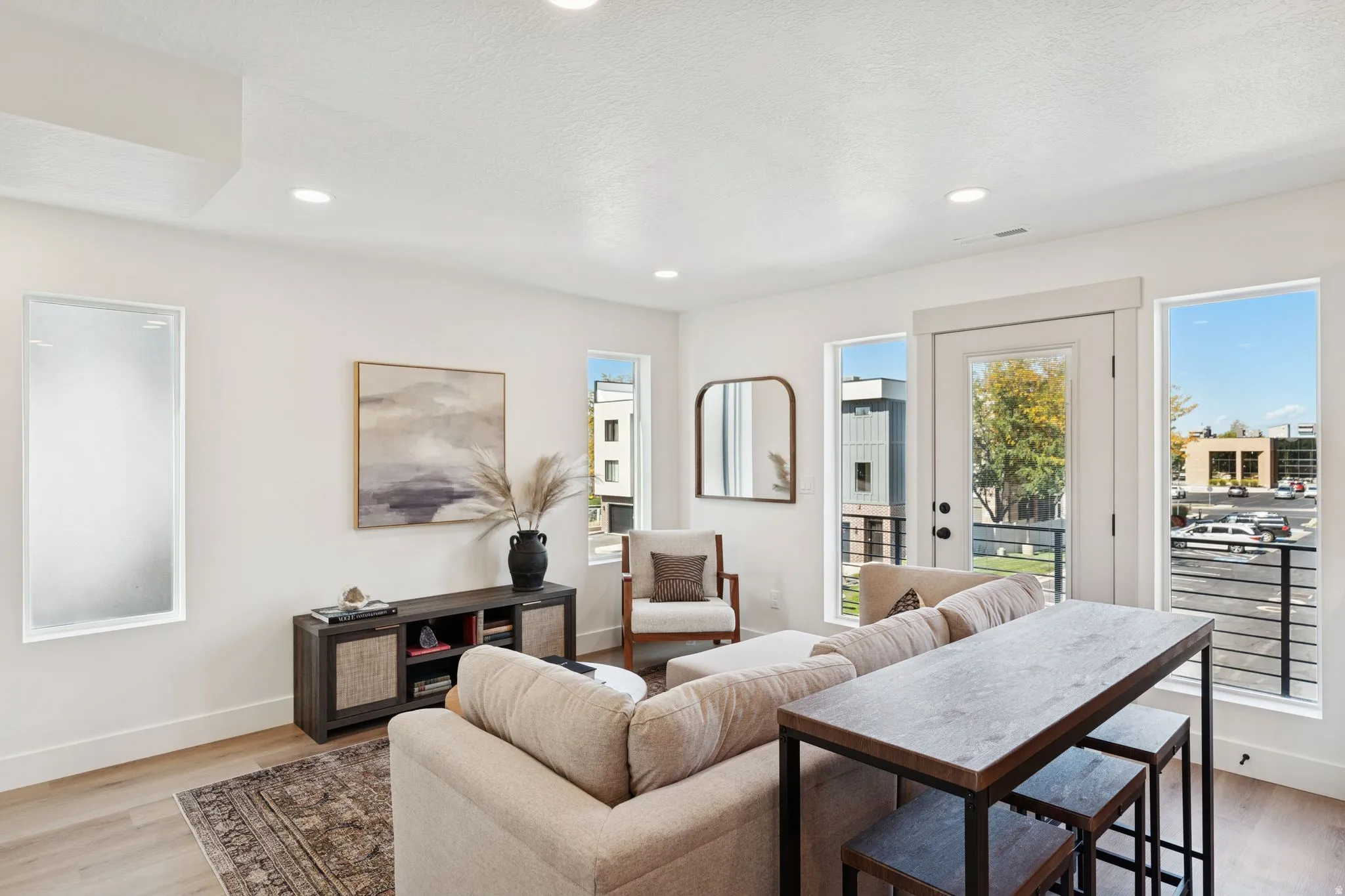 Living area featuring light wood-style flooring, recessed lighting, and a textured ceiling