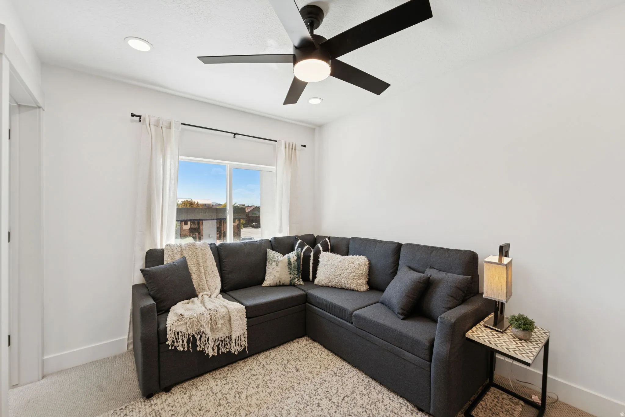 Living room featuring ceiling fan, carpet floors, and recessed lighting