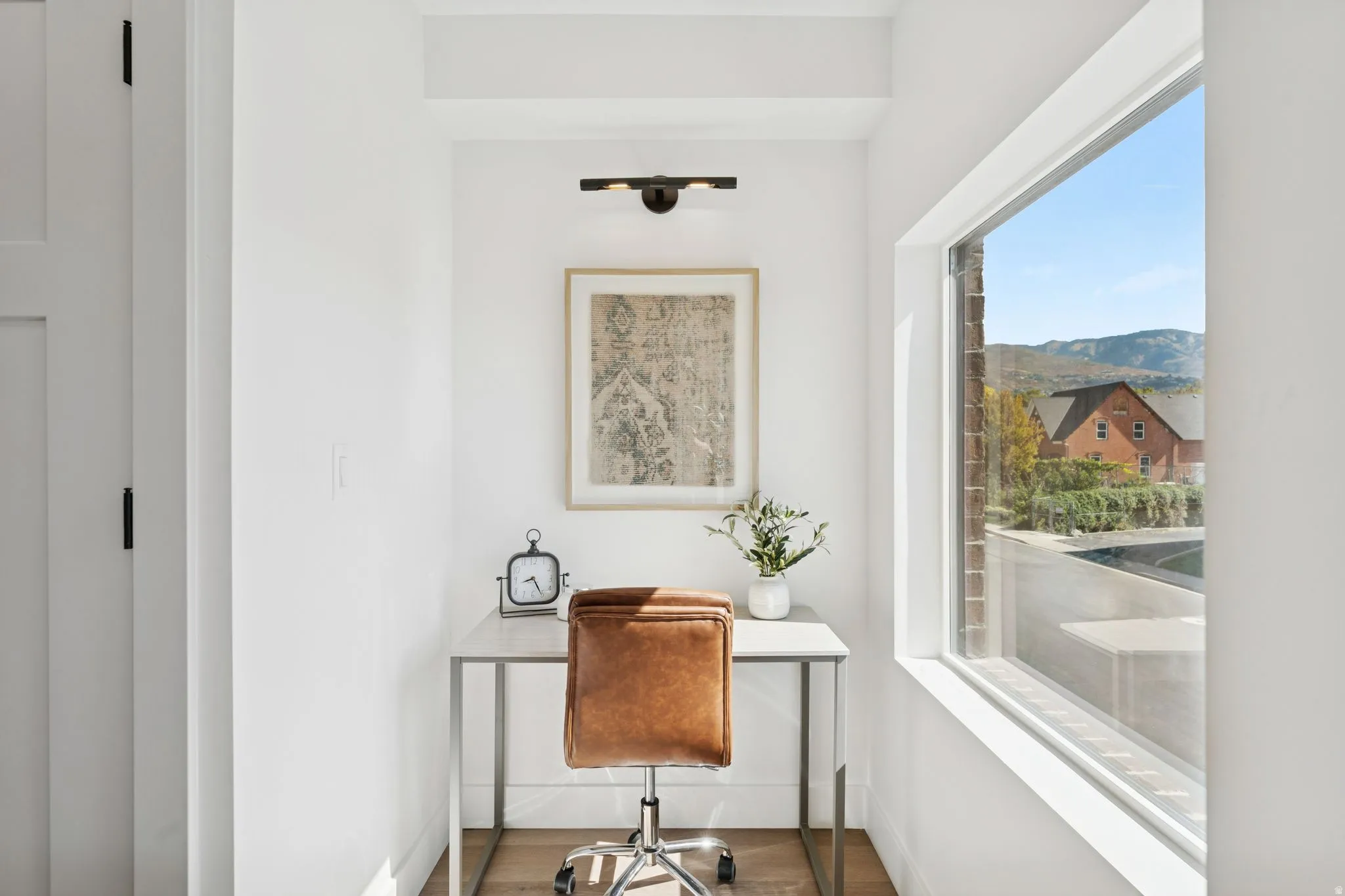 Office space with baseboards and wood finished floors