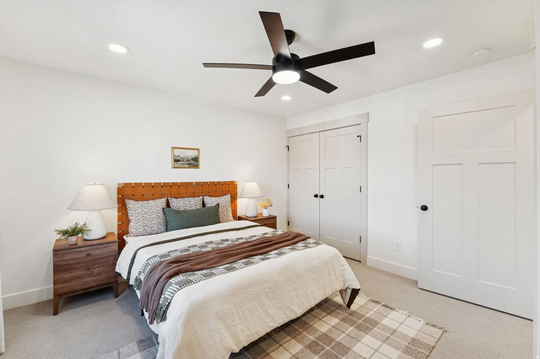 Bedroom with light carpet, a ceiling fan, a closet, and recessed lighting