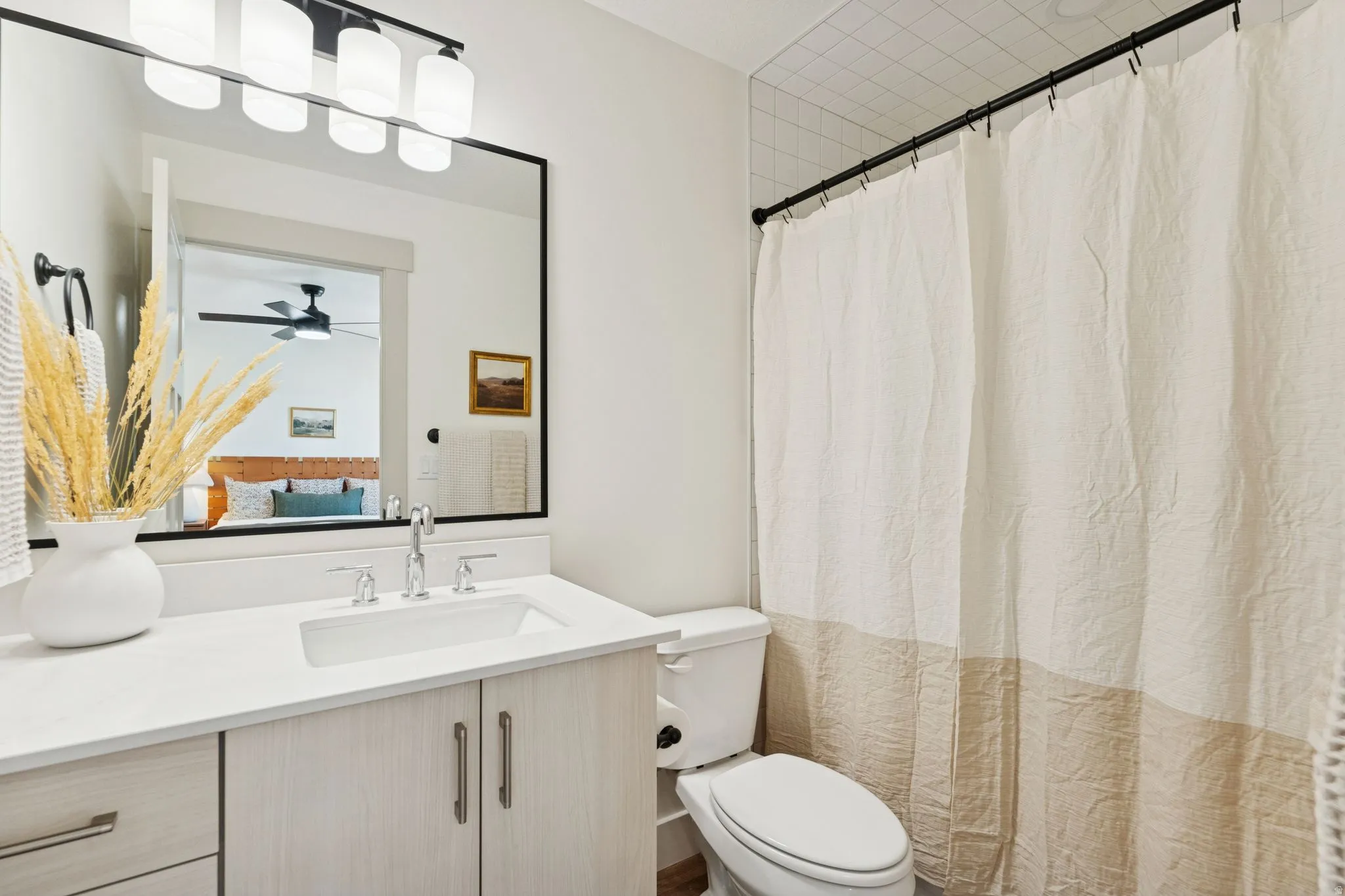 Ensuite bathroom featuring vanity and curtained shower