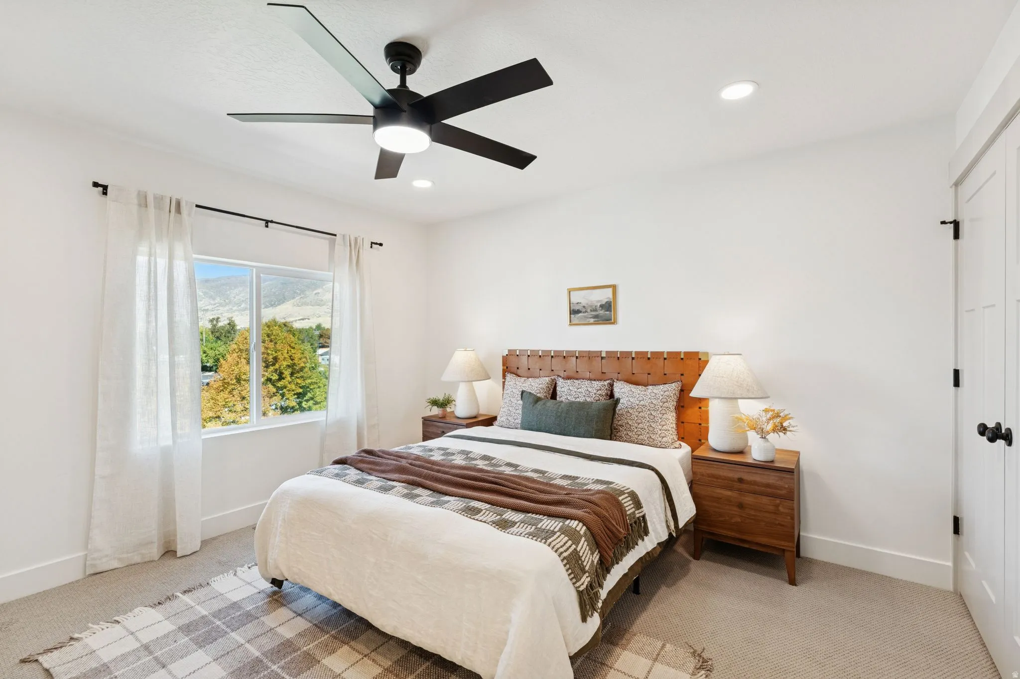 Bedroom featuring light carpet, ceiling fan, a closet, a mountain view, and recessed lighting