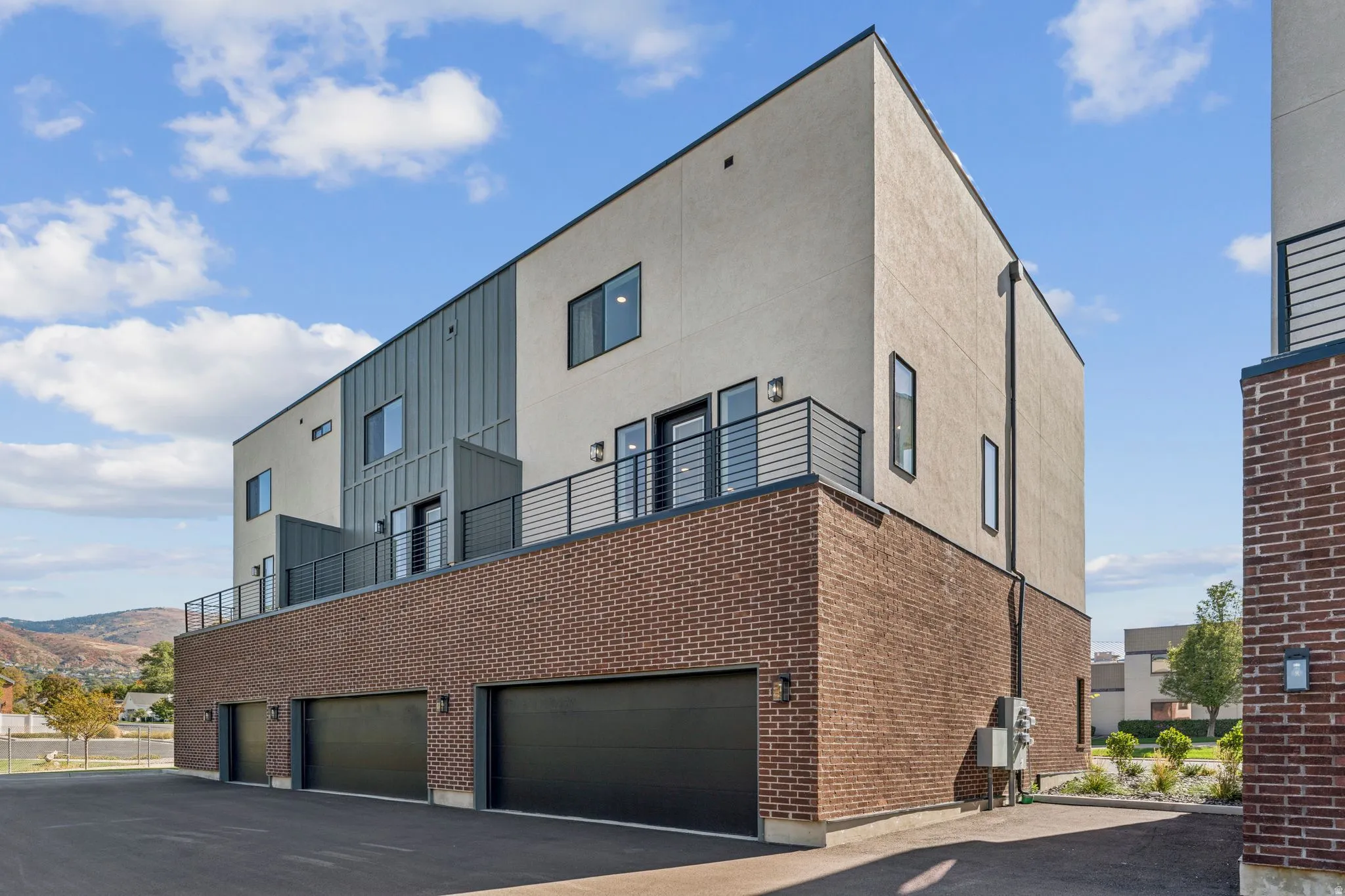 View of apartment building / complex featuring an attached garage
