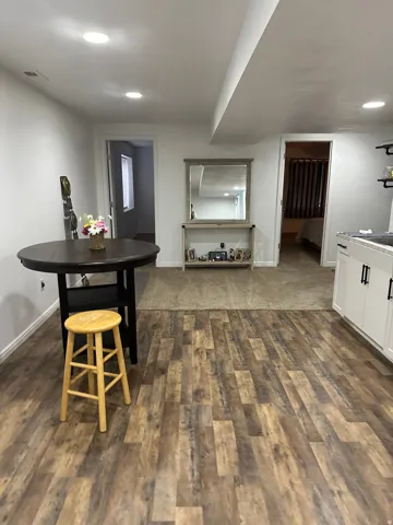 Dining room with dark wood-style floors and recessed lighting