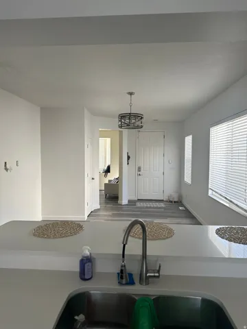 Kitchen featuring light countertops and hanging lights
