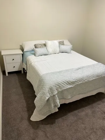 Bedroom with dark carpet