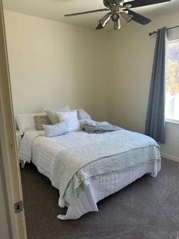 Bedroom with carpet flooring and ceiling fan