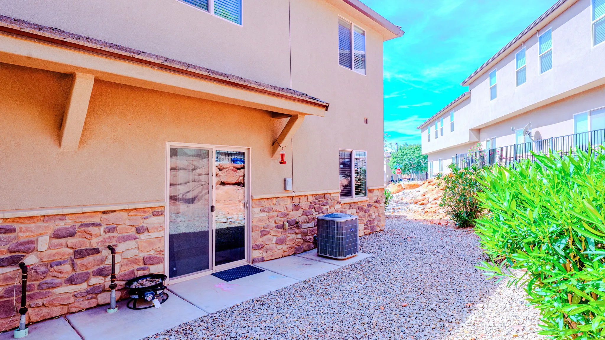 Property entrance featuring stone siding and stucco siding