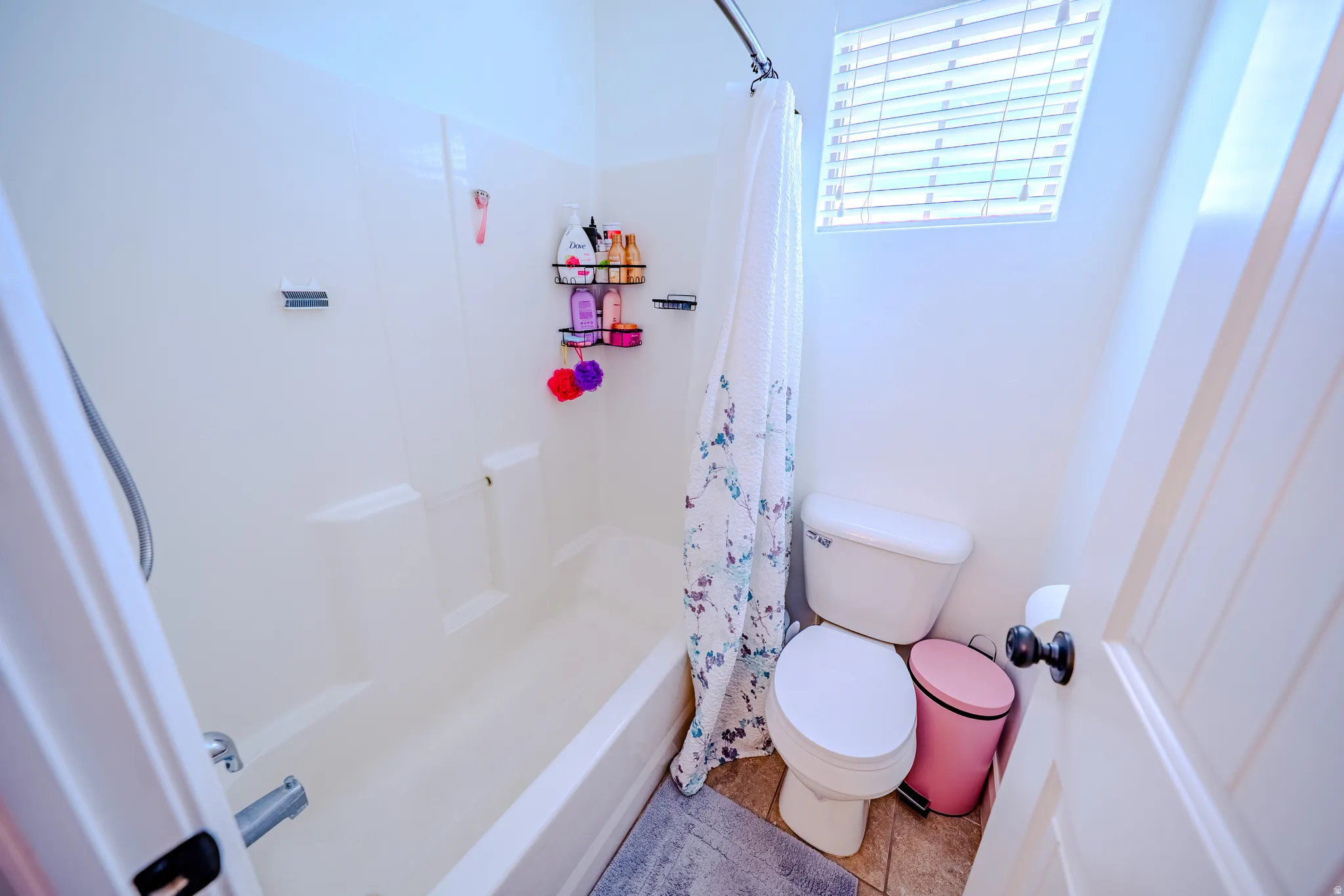 Full bath featuring toilet and shower / bath combo with shower curtain