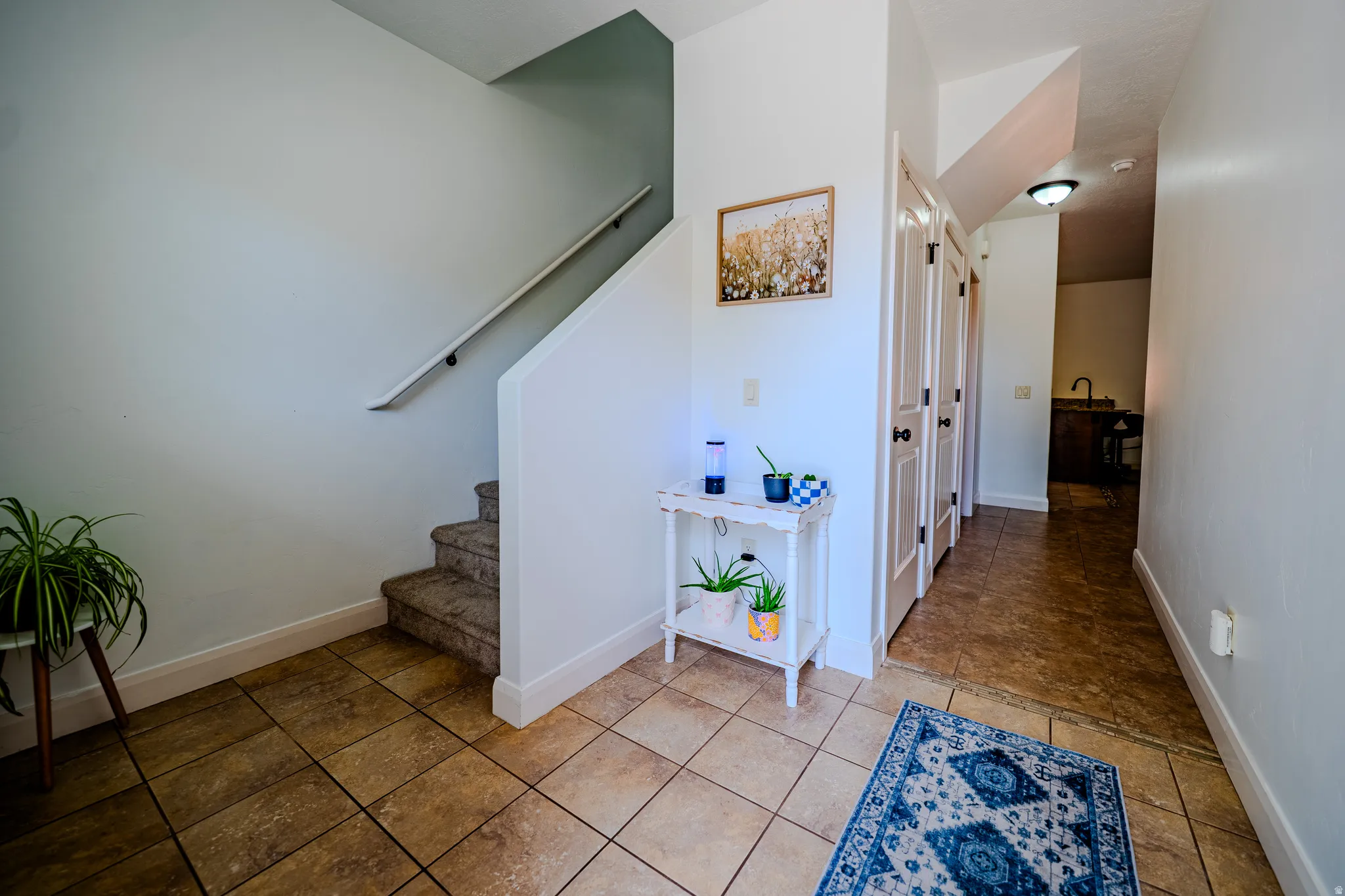 Stairs featuring baseboards and tile patterned floors