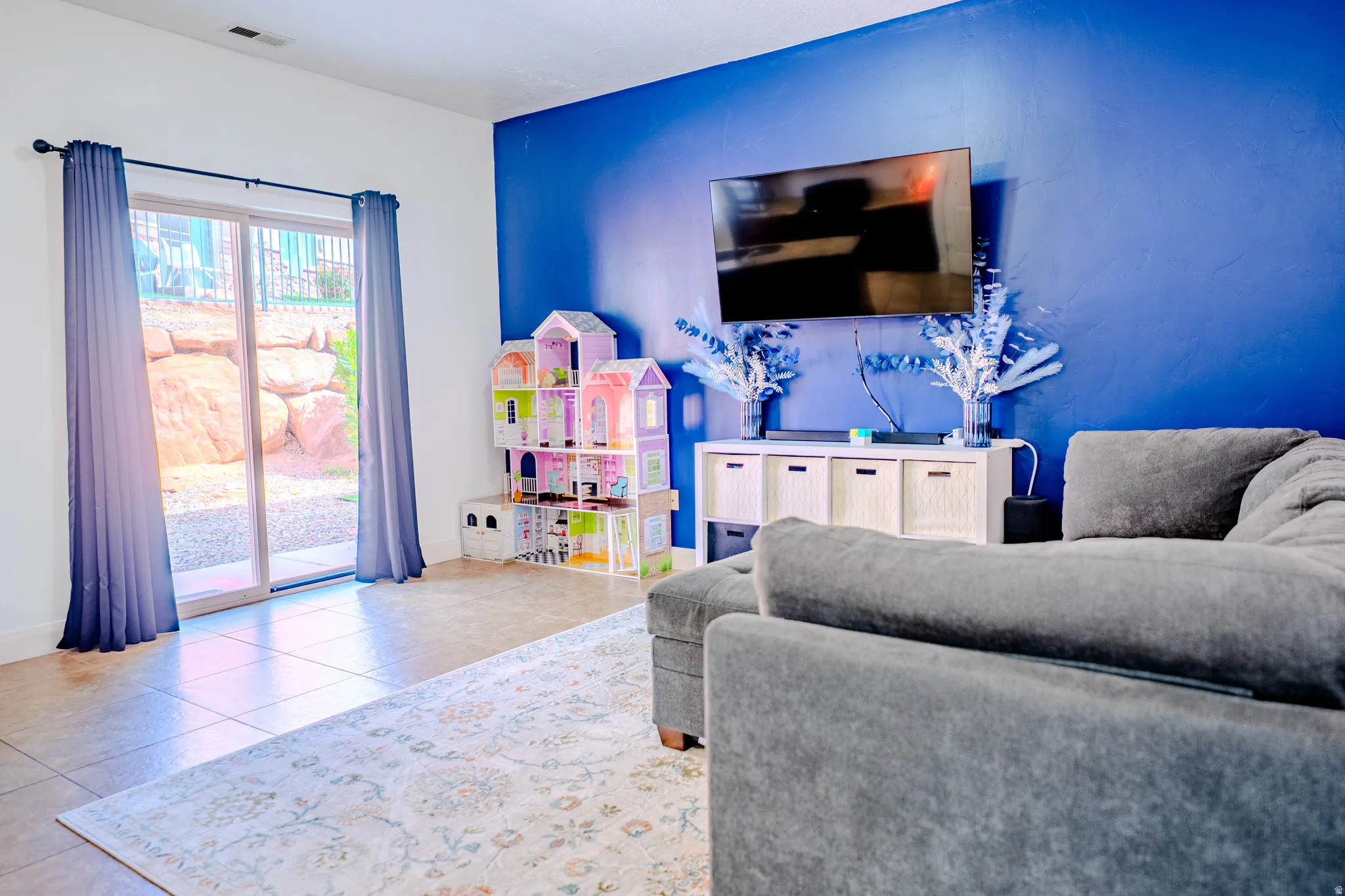 Living room with tile patterned floors and baseboards