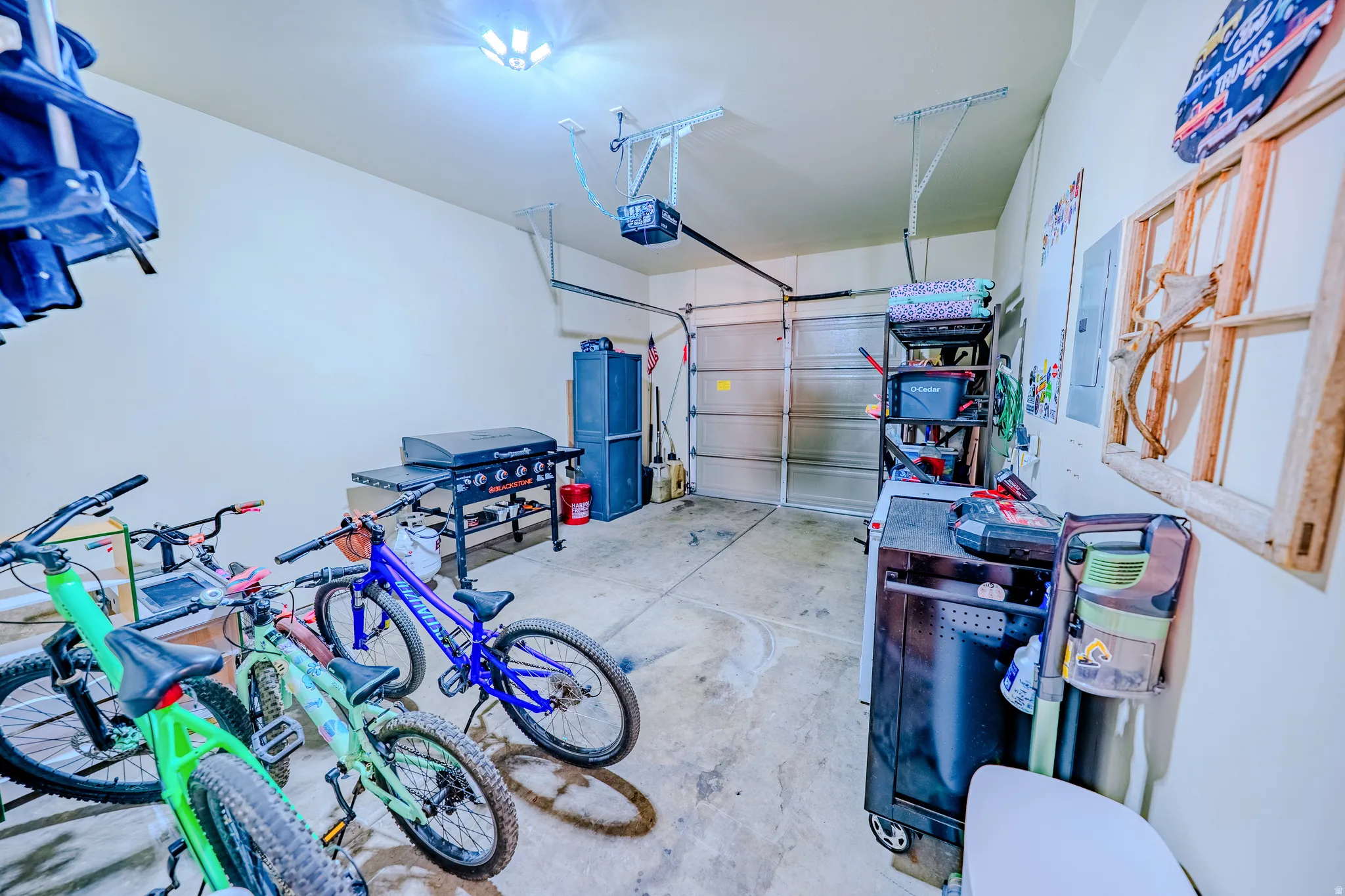 Garage with electric panel and a garage door opener