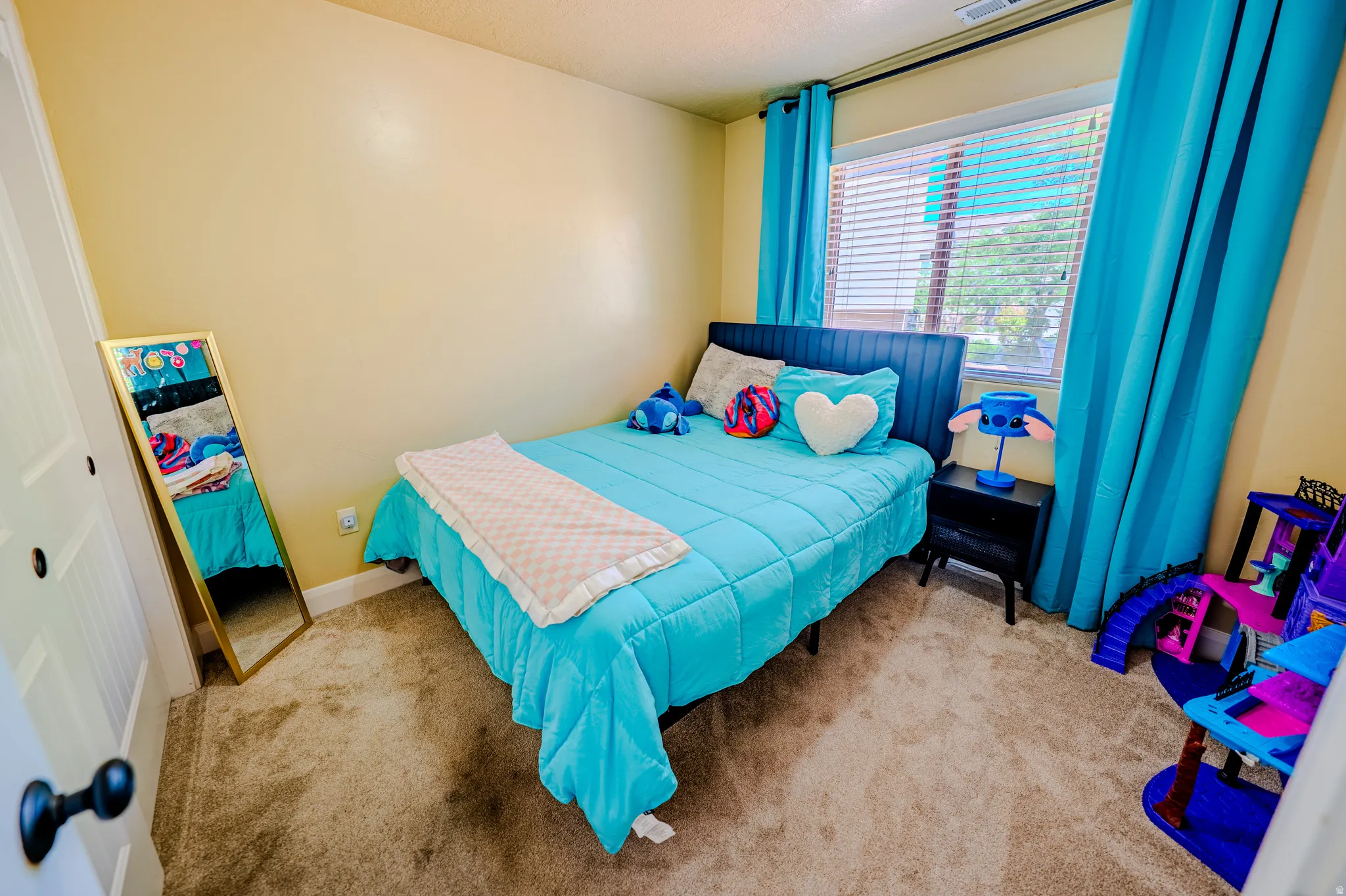 Bedroom featuring light colored carpet and a closet