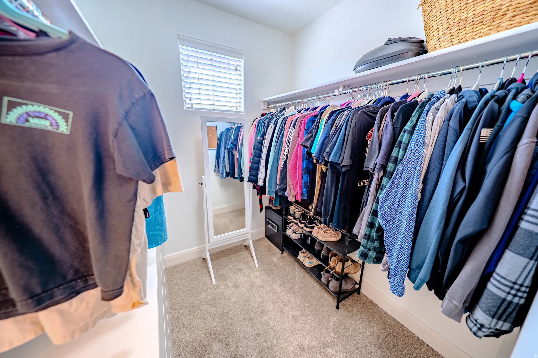 Walk in closet with light carpet