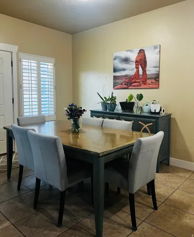 Dining space featuring tile flooring and a built-in sideboard