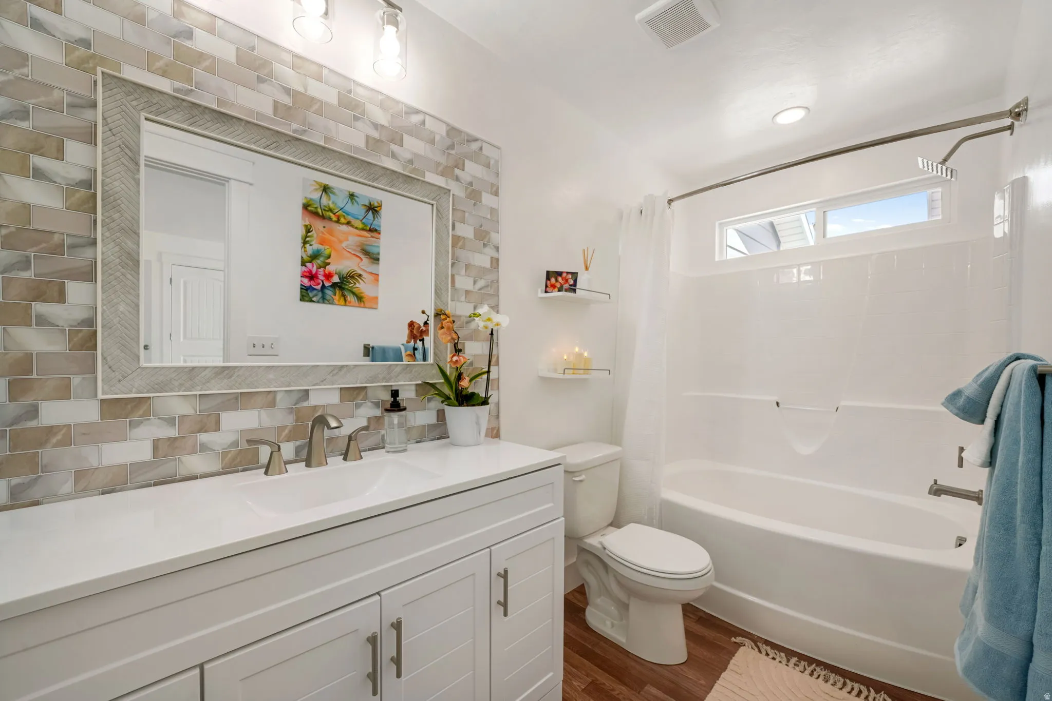 Primary full bath featuring vanity, shower / tub combo, tasteful backsplash, and dark wood-type flooring