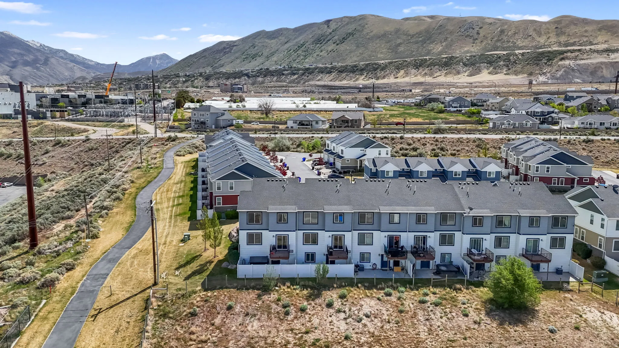 Bird's eye view of a mountain backdrop and walking trail