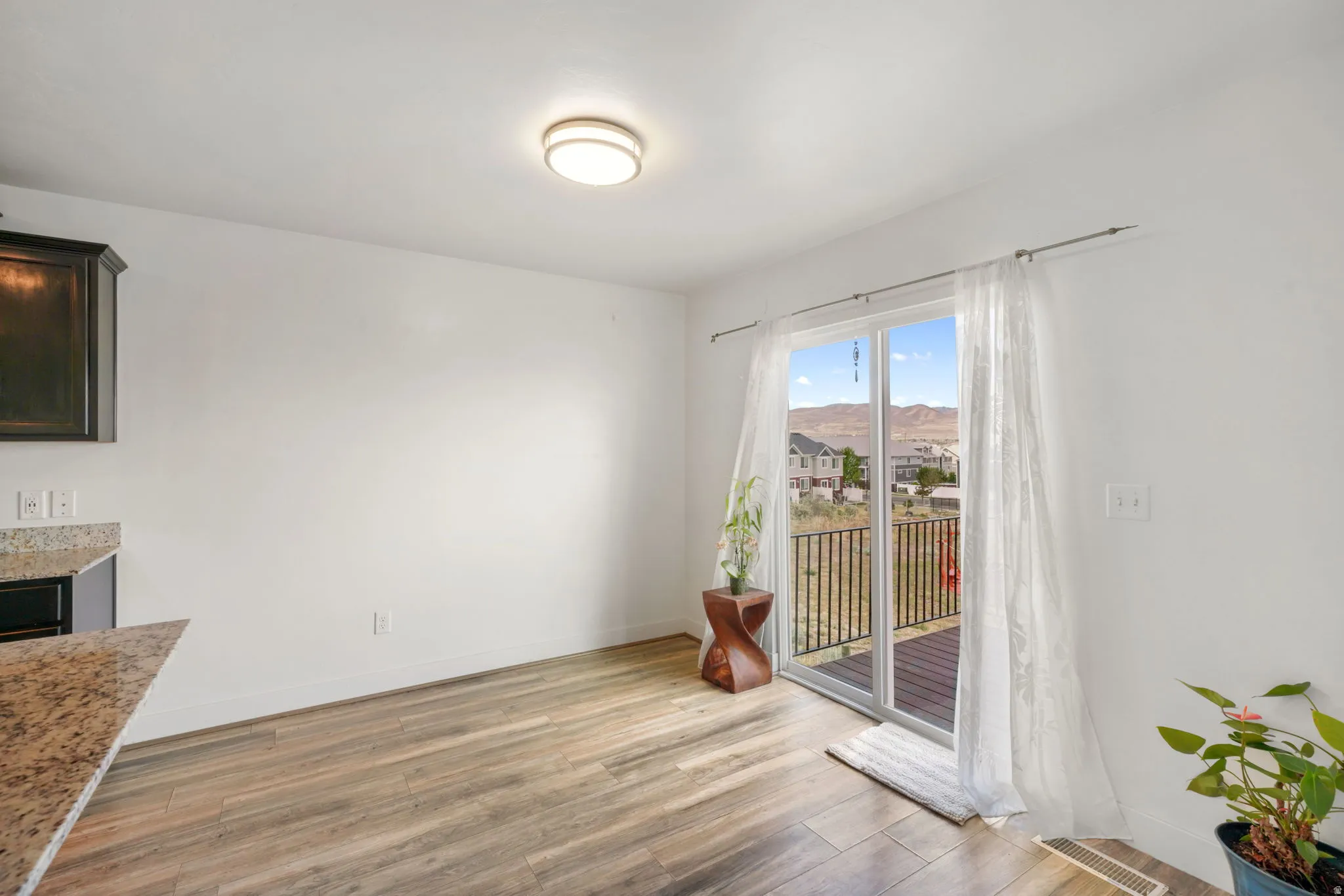 Unfurnished dining area featuring light wood-style floors and a mountain view
