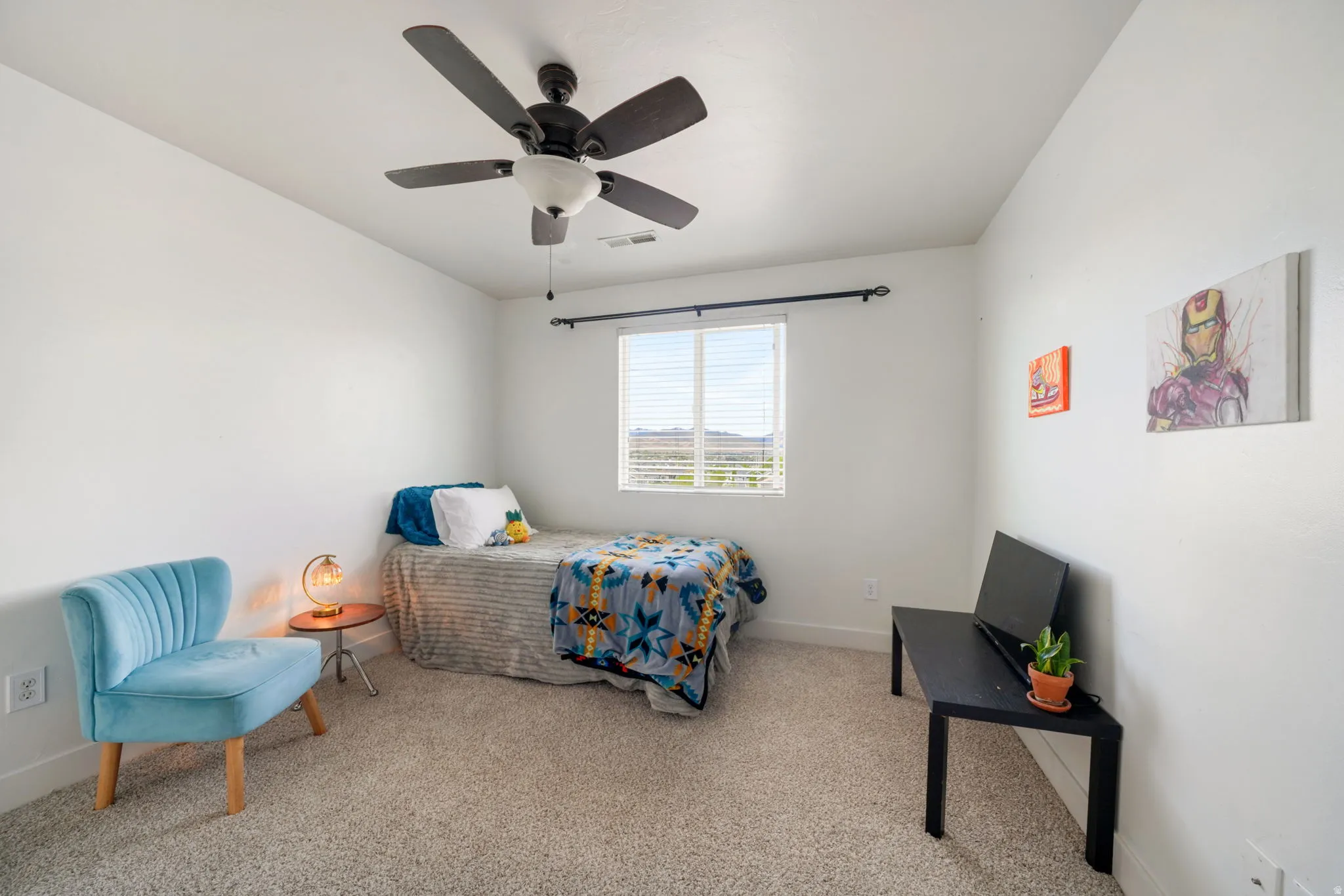 Bedroom with light carpet and ceiling fan