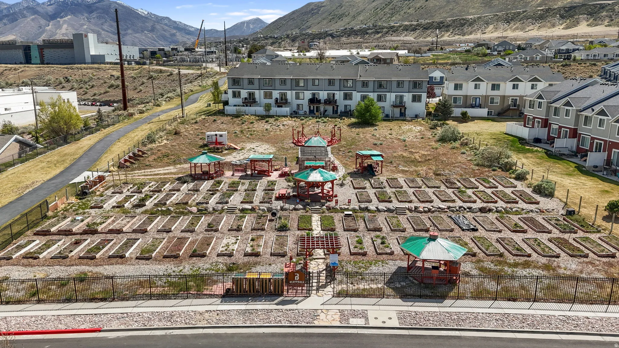 Aerial view of community gardens, featuring a mountainous background