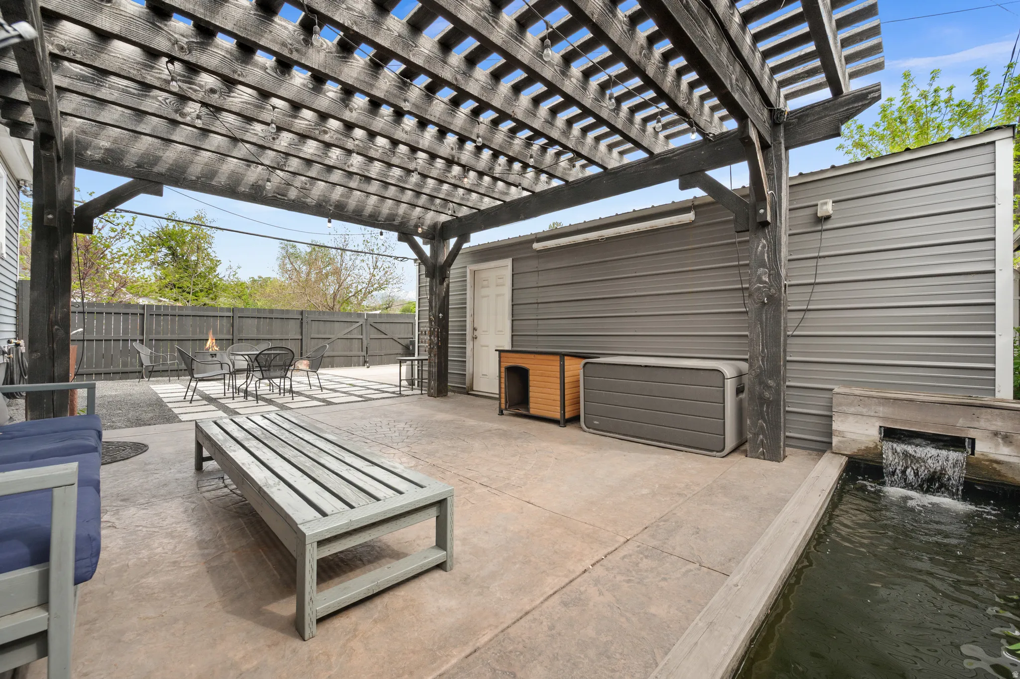 Fenced backyard featuring a patio area, a pergola, and outdoor dining area