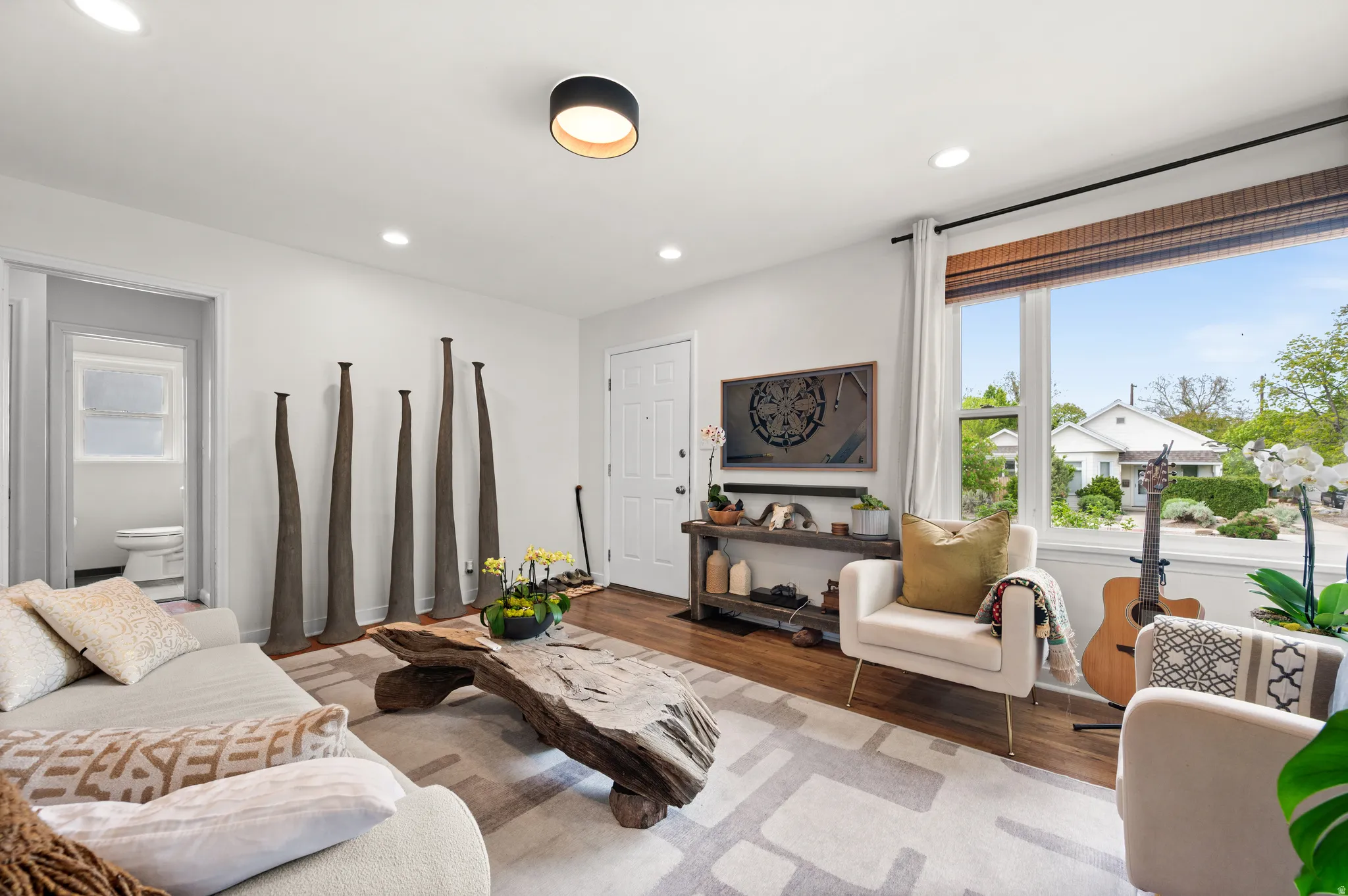 Living room with light wood-style flooring, healthy amount of natural light, and recessed lighting