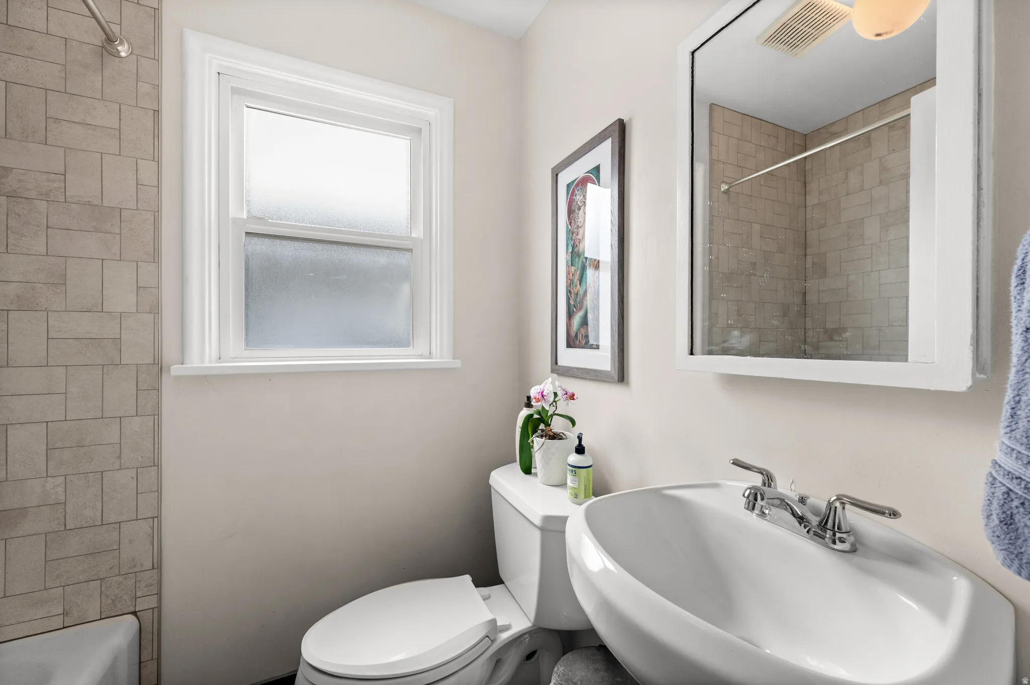 Full bathroom featuring toilet and bathing tub / shower combination