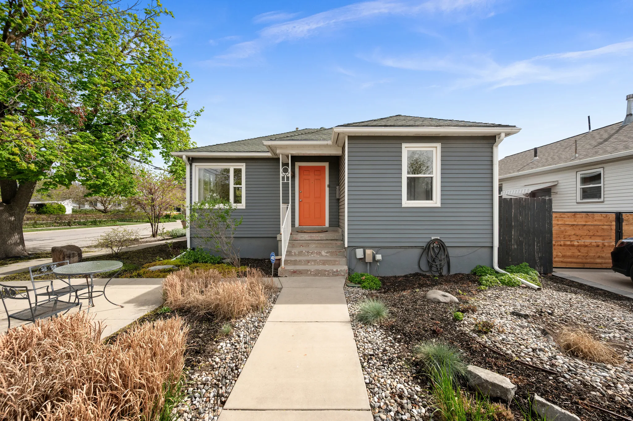 Bungalow with a shingled roof and entry steps